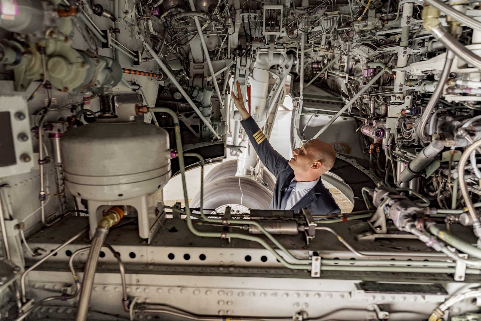 pilot-looking-technical-condition-aircraft-hangar